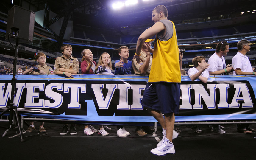 West Virginia's Cam Thoroughman high-fives a few fans en route to the locker room following the team's open practice on Friday, April 2, 2010, at Lucas Oil Stadium. (James Brosher / IU Student News Bureau)