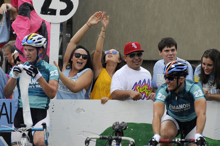 A few fans take part in a team chant during a heavy rain behind the Emanon pit during the Men's Little 500 on Saturday, April 24, 2010, at Bill Armstrong Stadium.