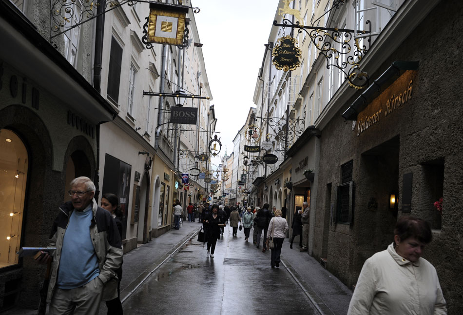 Visitors make their way down the Getreidegasse past shops and restaurants on Friday, May 21, 2010, in Salzburg, Austria. The pedestrian-only street is the Old City's central shopping district.