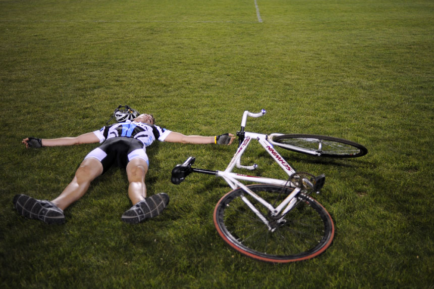 Emanon rider Justin Haviar collapses on the ground after making his way back to the turn three side of the infield after his Little 500 Individual Time Trial on Wednesday, March 31, 2010, at Bill Armstrong Stadium.