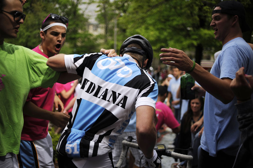 Fans high-five and attempt to hug Emanon rider Elliot Englert during a race-day send off for the team on Saturday, April 24, 2010, from the Alpha Tau Omega house.