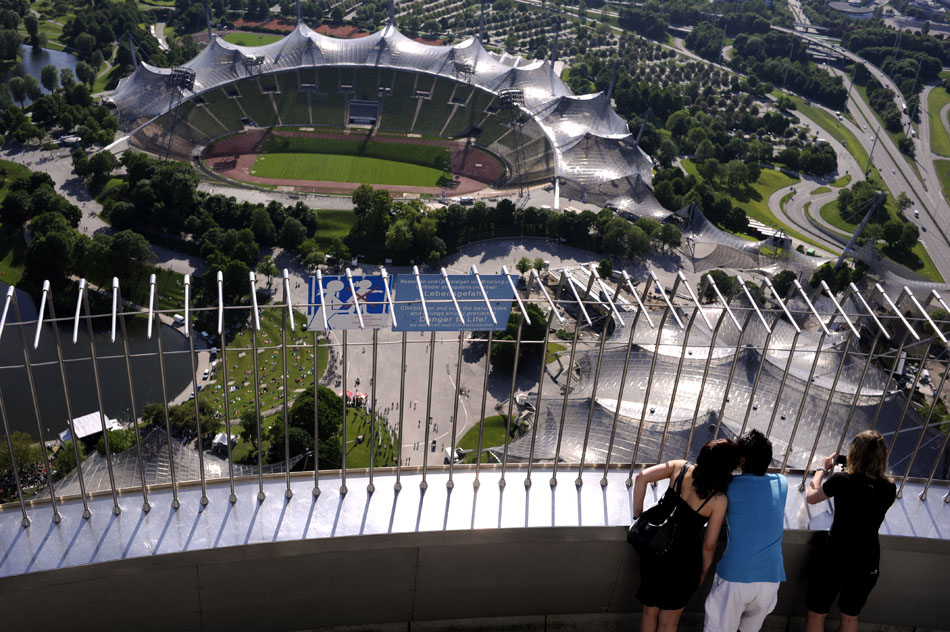 Visitors look down into the Olympic Stadium from a viewing platform on the Olympic Stadium on Monday, May 24, 2010, in Munich, Germany. The Olympic park hosted the 1972 Summer Olympics.