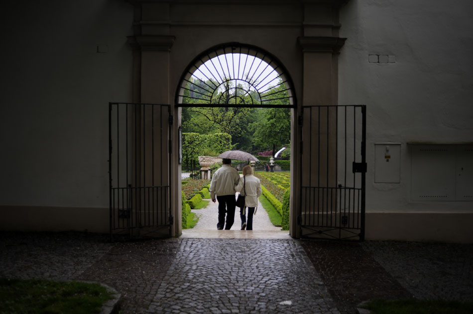 A couple walks down a set of stairs into the gardens at Mirabell Palace on Friday, May 21, 2010, in Salzburg, Austria.