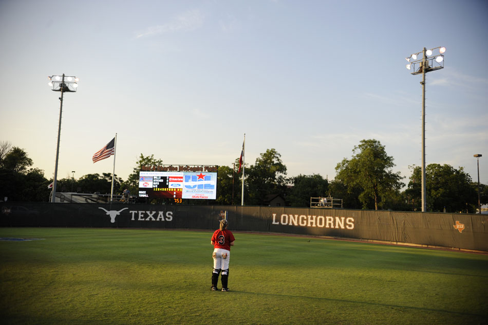 Bowie catcher Jaime Edwards takes a moment to herself alone in the outfield before a Class 5A softball semifinal against Tomball at the University of Texas on Friday, June 4, 2010.