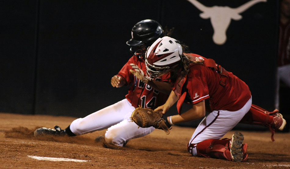 Bowie's Alli Akina slides into home as Tomball's Katie Doerre applies the tag during a Class 5A softball semifinal at the University of Texas on Friday, June 4, 2010.