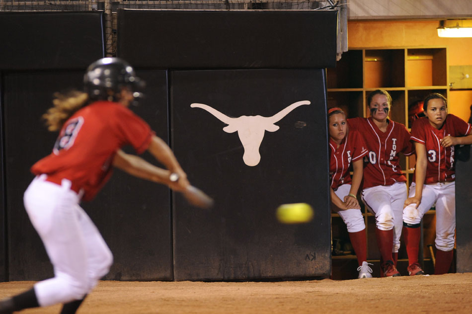 Tomball players watch as Bowie's Jillian Guerrero connects with a pitch during a Class 5A softball semifinal at the University of Texas on Friday, June 4, 2010. Bowie won 9-1.
