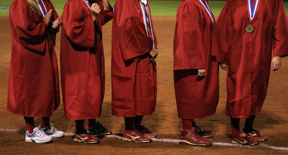 Tomball players line up on the third base line for a mock graduation ceremony after a 9-1 loss to Bowie in the Class 5A softball semifinal game at the University of Texas on Friday, June 4, 2010. The game conflicted with the school's commencement ceremonies so players received their diplomas after the game at home plate.