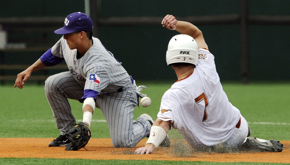 Texas' Jordan Etier slides safely into second base as a throw gets away from TCU's Jerome Pena during a NCAA Super Regional at Disch-Falk Field on Friday, June 11, 2010.