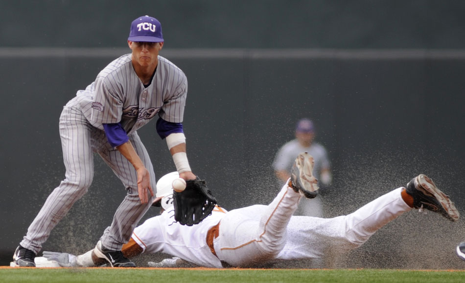 Texas' Kevin Keyes slides safely into second in front of a throw to TCU's Jerome Pena during a NCAA Super Regional at Disch-Falk Field on Friday, June 11, 2010.