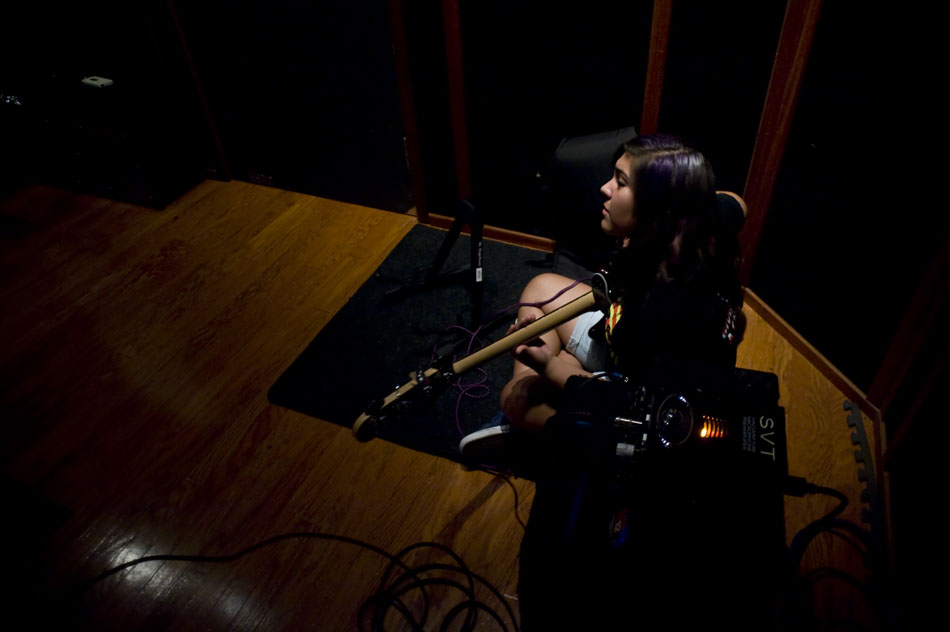 The Explosion of the Minds bassist Mercedes Salazar sits in the corner of a recording studio with her bass guitar as she waits for her group to start a recording session during Rock Camp USA at the Austin School of Music on Wednesday, July 21, 2010.