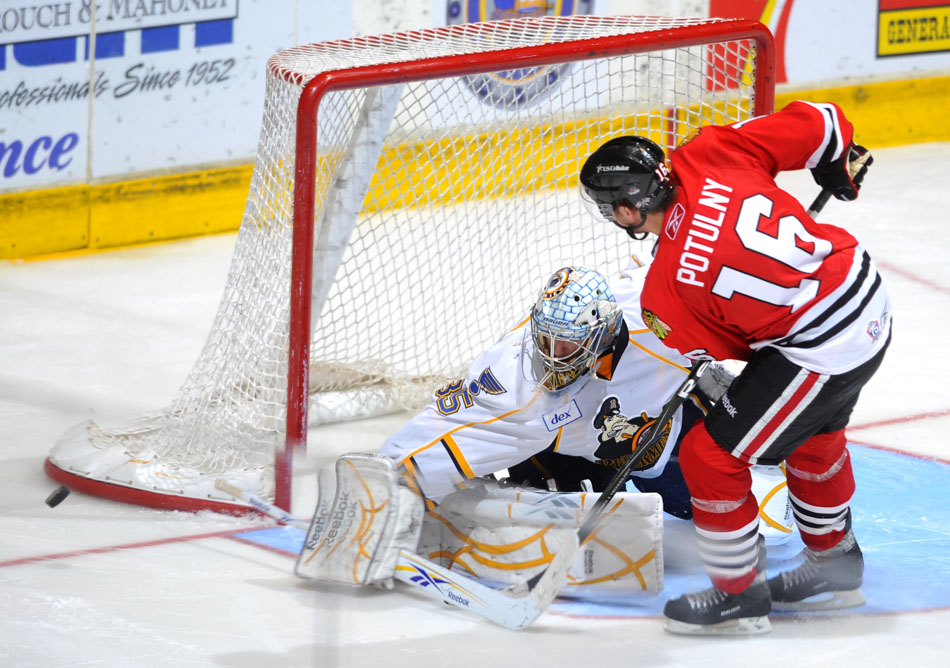 Peoria goalie Jake Allen makes a save as the puck zips wayward of the goal after a shot from Rockford's Ryan Potulny during a shootout in a game on Sunday, Nov. 21, 2010, at Carver Arena.