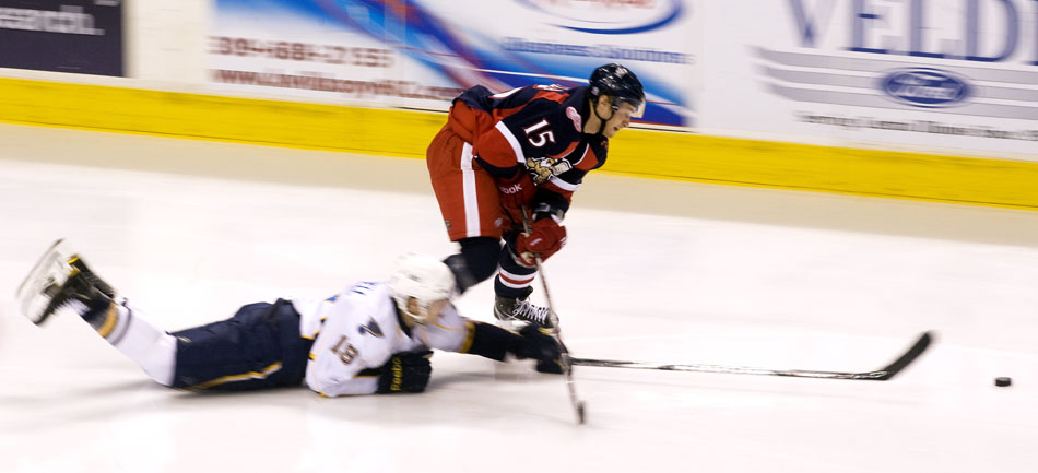 Grand Rapids Griffins forward Ilari Filppula (15) plays the puck as Peoria Rivermen right wing Adam Cracknell (19) slides on the ice during a game on Saturday, Dec. 11, 2010, at Carver Arena.