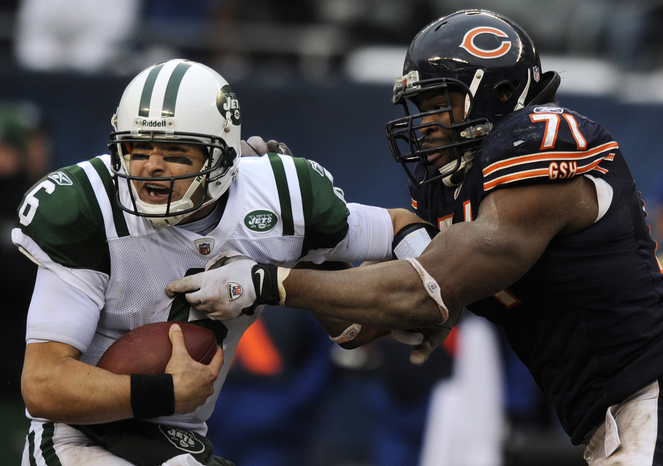 New York  Jets quarterback Mark Sanchez (6) reacts as he tries to avoid a sack from Chicago Bears defensive tackle Israel Idonije (71) during the second half of a game on Sunday, Dec. 26, 2010, in Chicago. Chicago won 38-34.