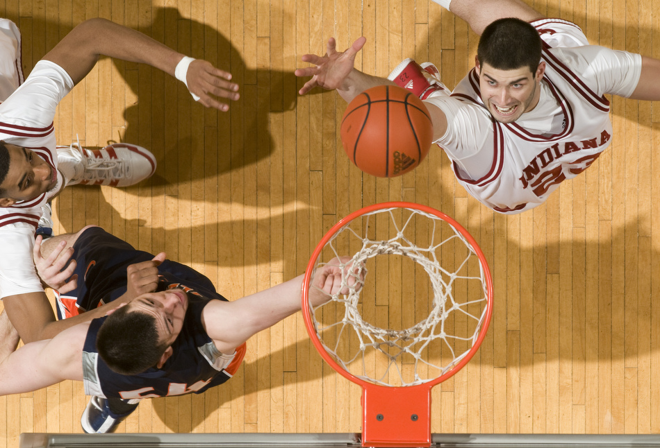 Indiana forward Bobby Capobianco, right, reaches out to grab a rebound in front of Illinois center Mike Tisdale during the second half of IU's 66-60 loss to Illinois on Saturday, Jan. 9, 2010, at Assembly Hall.