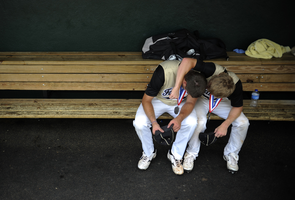 Bushland players Monty McCasland, left, and Thomas Cleveland share a moment in the dugout after a loss in the Class 2A state championship game at the University of Texas on Thursday, June 10, 2010.
