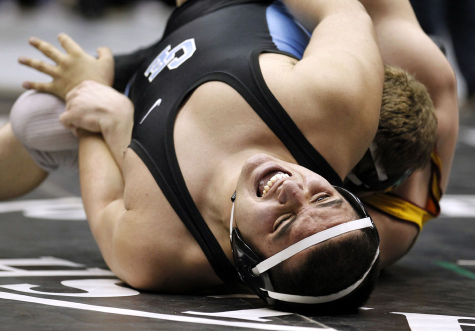 Cheyenne East's Michael Galicia reacts as he's twisted by Star Valley's Dawson Loveland during a semi-final match in the 4A 215 pound weight class on Friday, Feb. 25, 2011, in Casper, Wyo. Loveland won the match.