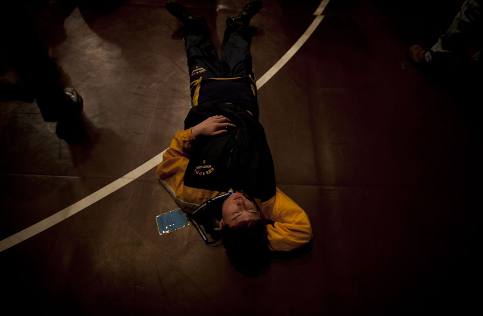 Greybull wrestler Nathen Gossens takes a nap during the March of Champions at the Wyoming state wrestling finals on Friday, Feb. 25, 2011, in Casper, Wyo.