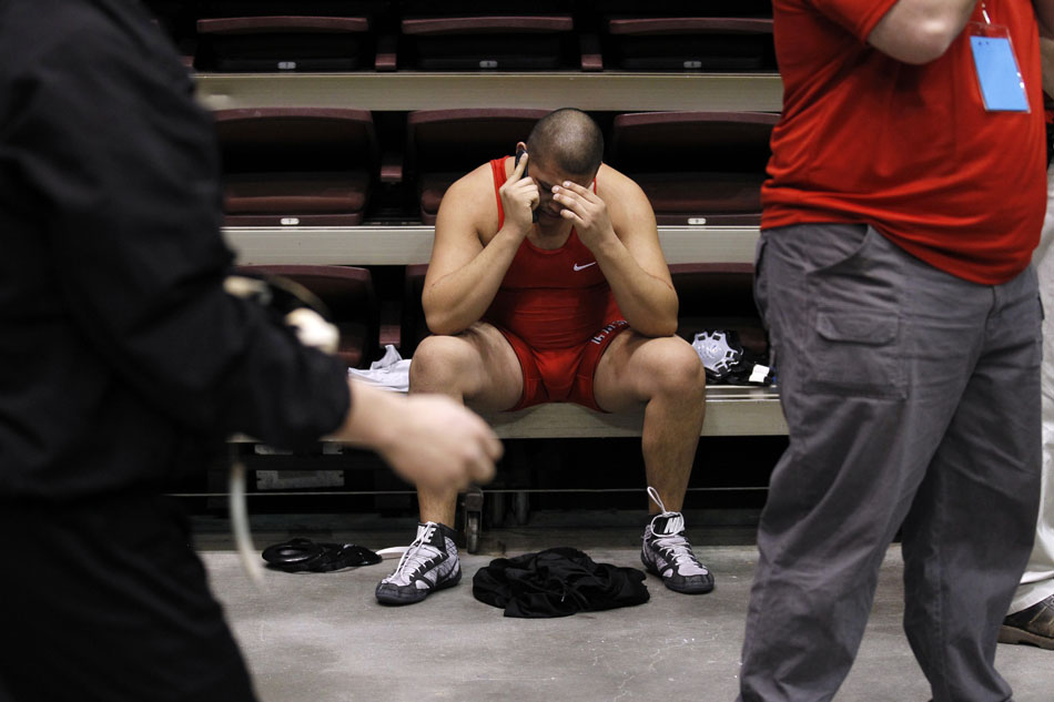 Cheyenne Central's Leon Romero talks on the phone after a loss to Natrona County's Greg Lensert in a Class 4A 215-pound wrestleback match during the Wyoming high school state wrestling tournament on Saturday, Feb. 26, 2011, in Casper, Wyo.