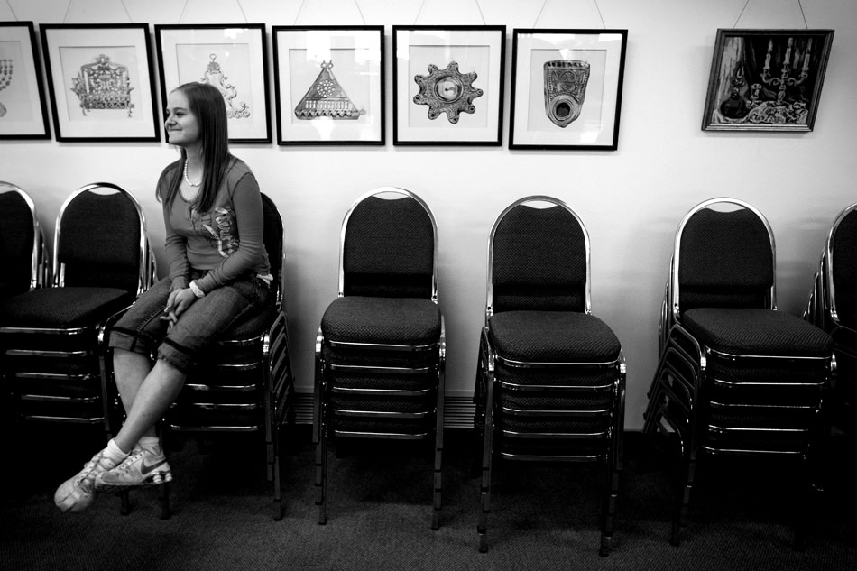 Nathalia Rap, age 16, takes a break on a stack of chairs after a Hebrew School lesson Sunday, Feb. 27, 2011, at the Mount Sinai Congregation in Cheyenne. The class included prayers, a meal and dancing.