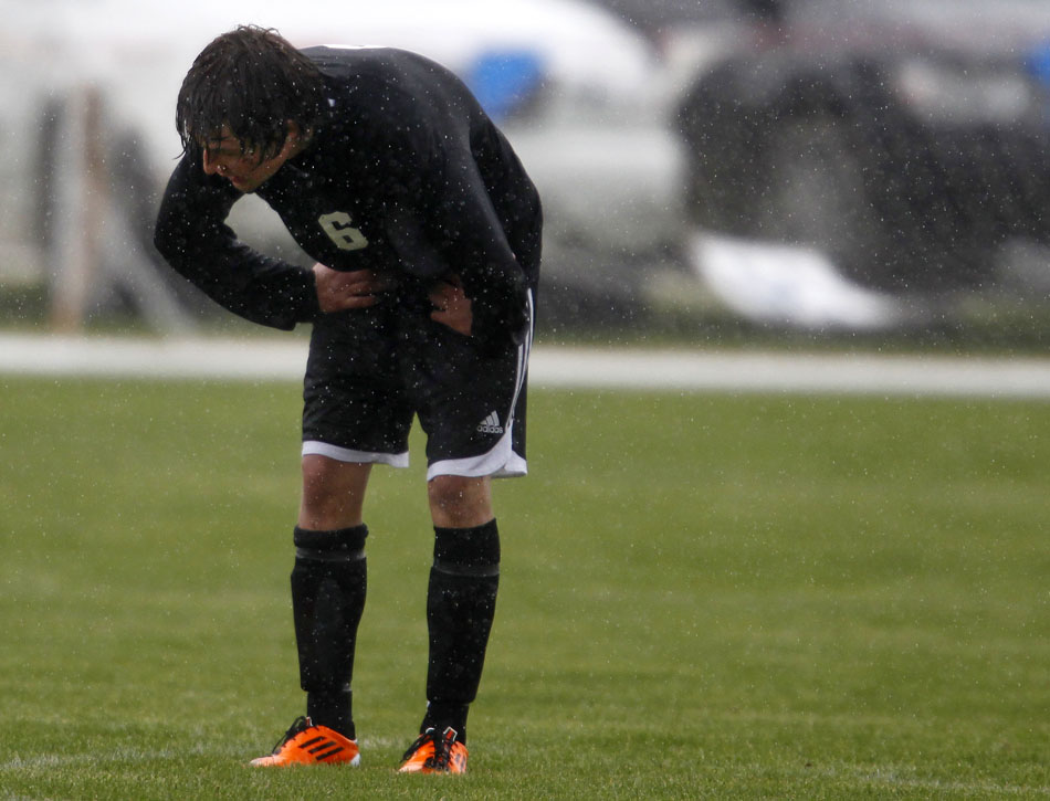 Cheyenne East's Clay Casey waits for the action to restart in the rain during a boy's state soccer quarterfinal on Thursday, May 19, 2011, in Sheridan, Wyo.