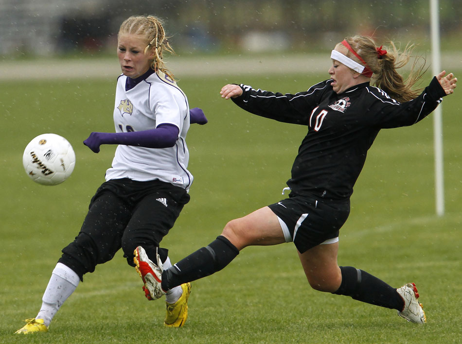 Cheyenne Central's Halee Moore (10) slides in to kick the ball away from Gillette's Madi Moore during a Class 4A girl's state soccer semifinal on Friday, May 20, 2011, in Sheridan, Wyo.