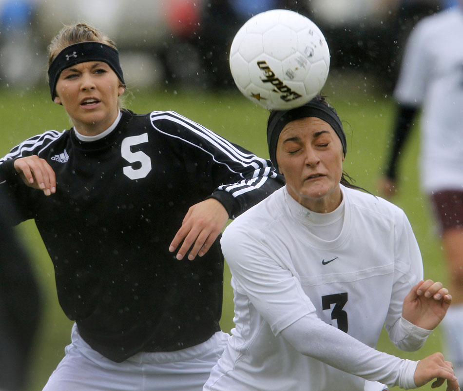 Laramie's Lindsey Martinez (3) heads the ball away from Cheyenne East's Chelsea Crampton-Weber during a Class 4A girl's state soccer semifinal on Friday, May 20, 2011, in Sheridan, Wyo.
