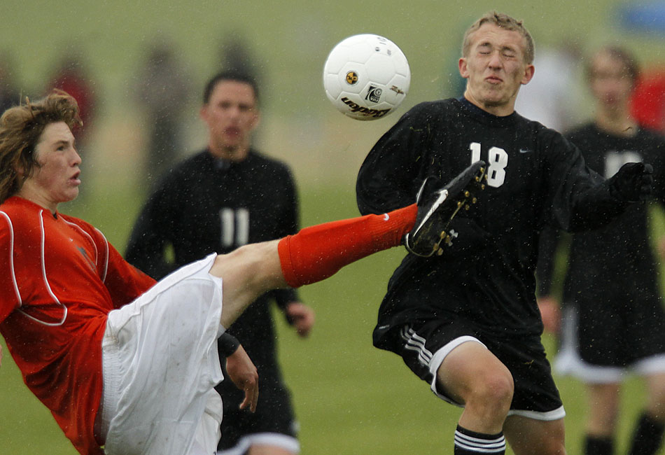 Rock Springs' Austin Lever, left, kicks the ball away from Cheyenne East's Ian Done (18) during a Class 4A boy's state soccer game on Friday, May 20, 2011, in Sheridan, Wyo.