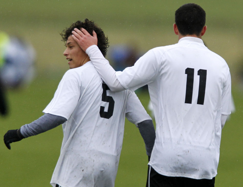 Cheyenne East's Trey Herrera (11) pats teammate Jalen Willet (5) on the back of the head after Willet scored a goal during a Class 4A boy's state soccer fifth place game on Saturday, May 21, 2011, in Sheridan, Wyo.