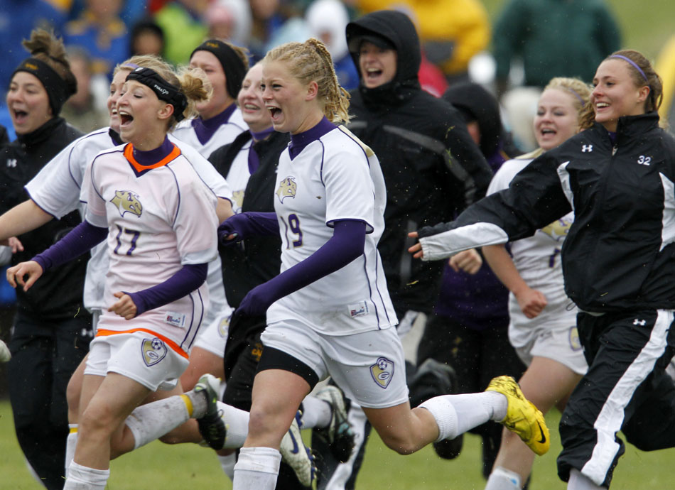 Gillette players storm the pitch after a 2-1 (3-1) shootout win against Laramie in the Class 4A girl's state soccer championship game on Saturday, May 21, 2011, in Sheridan, Wyo.
