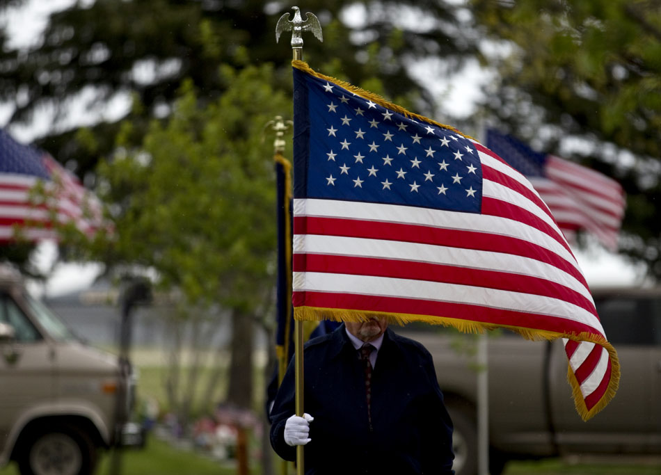 An American flag blows in the wind and rain during a Memorial Day ceremony on Monday, May 30, 2011, at Beth El Cemetery in Cheyenne.