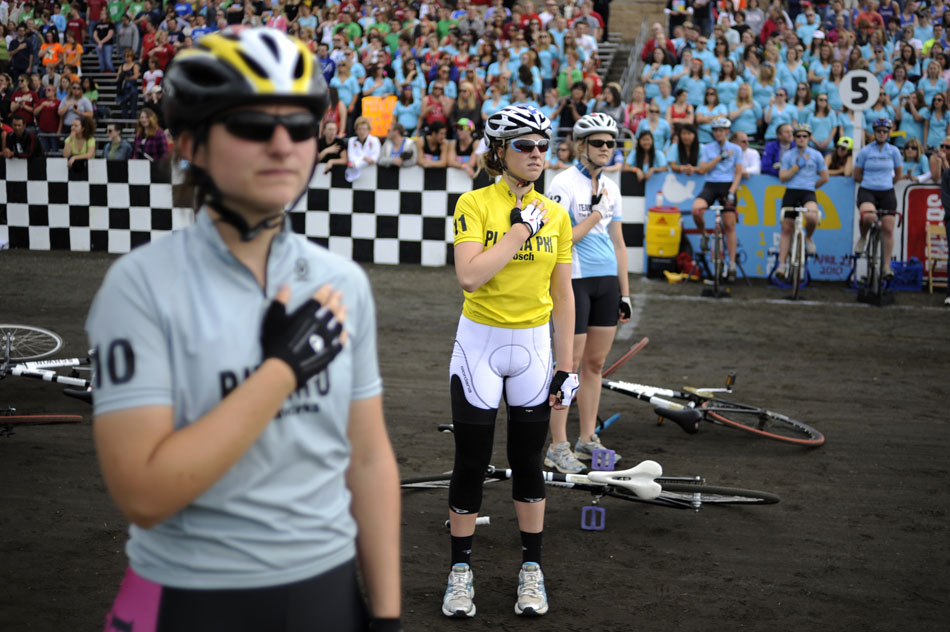 Phi Beta Phi rider Caroline Brown, middle, watches an American flag wave during the playing of the National Anthem before the start of the Women's Little 500 on Friday, April 23, 2010, at Bill Armstrong Stadium. (James Brosher/Bloomington Herald-Times)