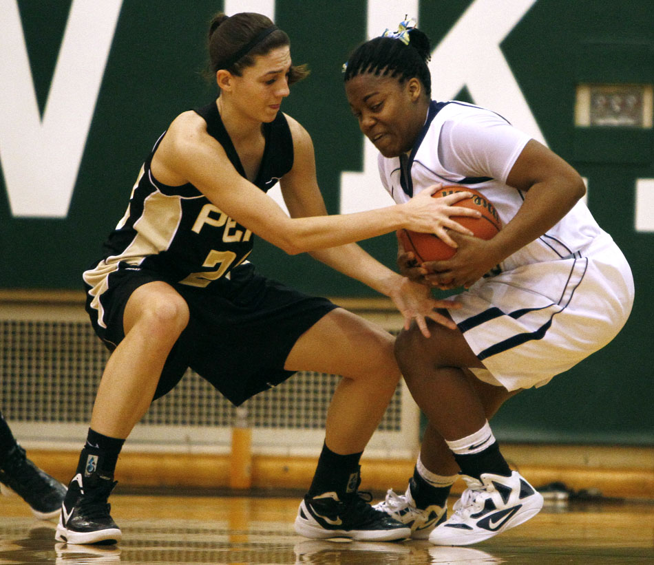 Penn's Caroline Buhr, left, tries to strip the ball away from Michigan City's Jameka Collins during a Class 4A basketball regional against Michigan City on Saturday, Feb. 18, 2012, at Valparaiso High School. Penn won 59-55. (James Brosher/South Bend Tribune)