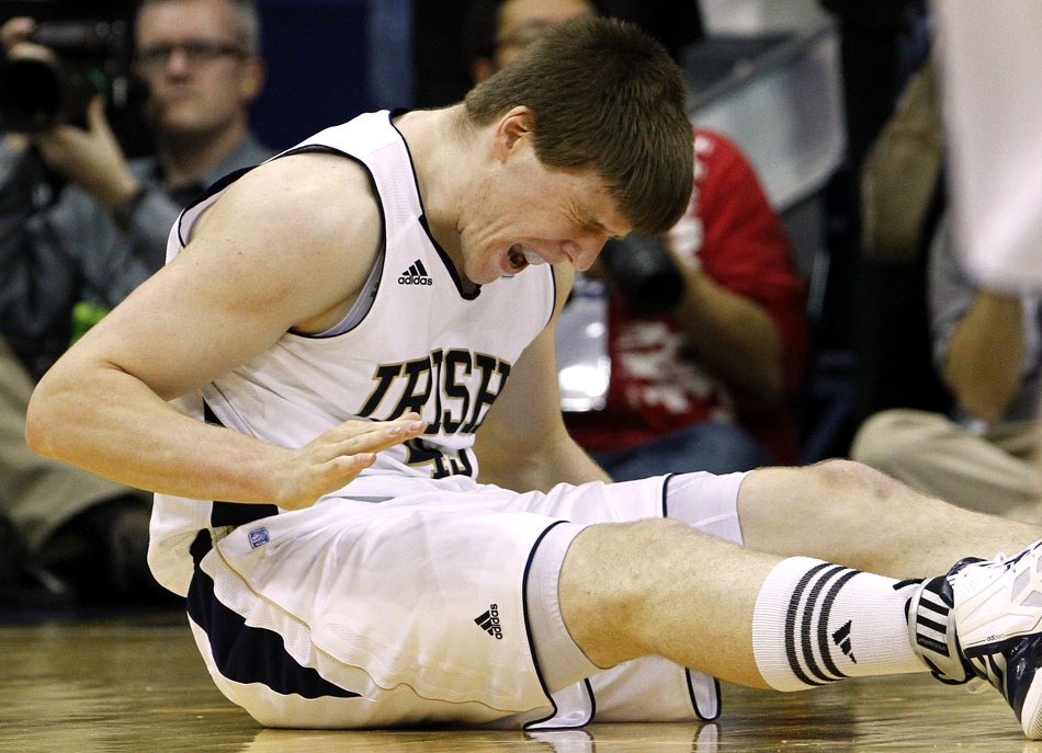 Notre Dame forward Jack Cooley slams his hands on the hardwood in frustration after he was unable to come up with the ball in a scramble during a college basketball game on Wednesday, Feb. 22, 2012, at the Purcell Pavilion in South Bend. (James Brosher/South Bend Tribune)