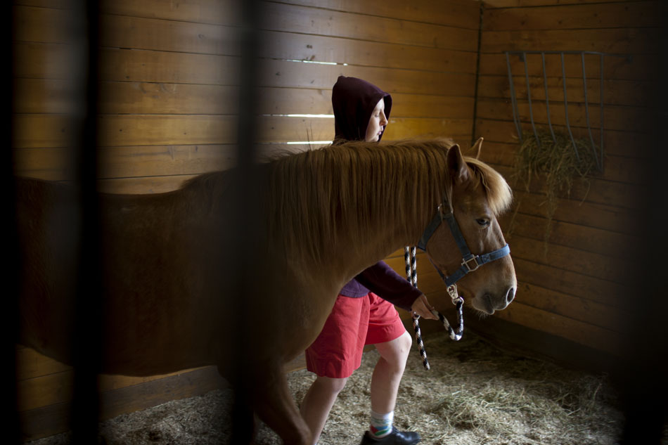 April Boughton moves a 4-year-old horse named Beauty back to her stall as Boughton works in the stables on Friday, April 20, 2012, at Hannah and Friends in South Bend. Boughton, 22, comes to stables to groom the horses once a week. (James Brosher/South Bend Tribune)