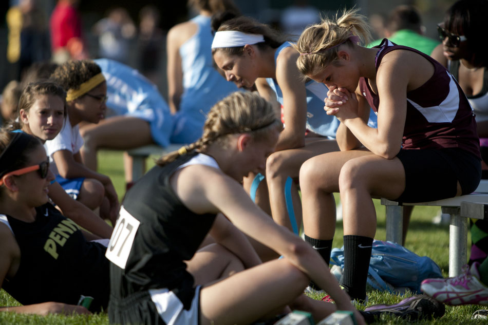 Mishawaka's Ashley Spence, right, takes a moment to herself as she waits to take part in an event during the Bremen girl's track and field sectionals on Tuesday, May 15, 2012, at Bremen High School. (James Brosher/South Bend Tribune)