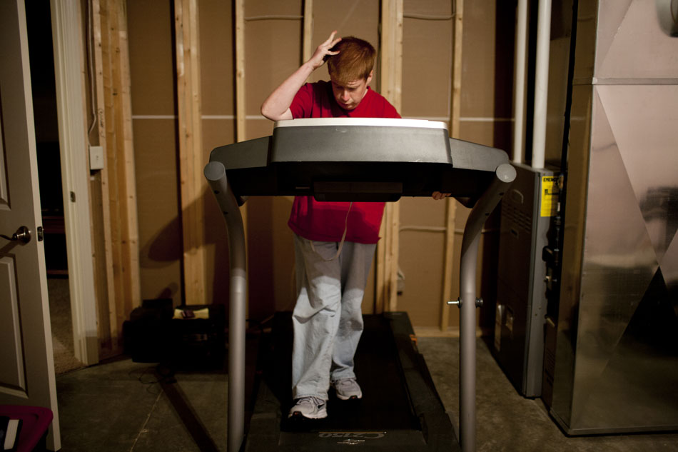 Greg Gaver walks on a treadmill in his family's basement on Wednesday, April 25, 2012, in Granger. Gaver, 21, usually exercises everyday for 30 minutes to help with his Prader-Willi Syndrome, which makes him have an intense craving for food. If not kept in check, the syndrome can lead to extreme binge eating and obesity related conditions such as Type 2 diabetes, according to the Mayo Clinic. (James Brosher/South Bend Tribune)