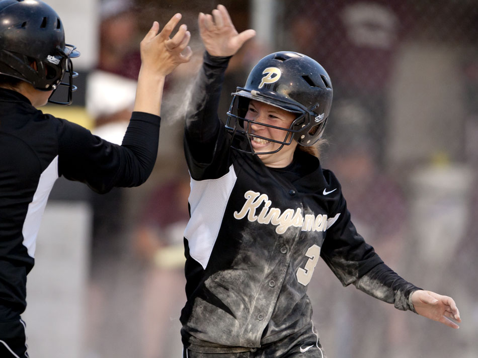 Penn's Alyssa Davis (3) high fives teammate Claryce Gedde after Davis scored a run in the bottom of the sixth inning to give Penn a 6-3 advantage over Mishawaka in a softball sectional game on Tuesday, May 22, 2012, at Penn High School in Mishawaka. Penn would hold off Mishawaka for the win. (James Brosher/South Bend Tribune)
