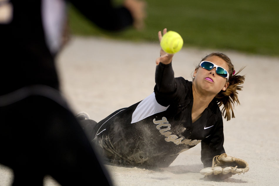 Penn's Alexis Ball flips the ball from the ground to first baseman Sydney Tom for an out during a softball sectional game on Tuesday, May 22, 2012, at Penn High School in Mishawaka. (James Brosher/South Bend Tribune)
