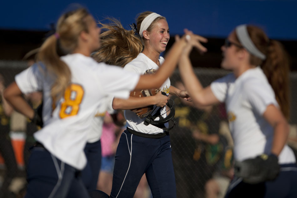 Riley's Morgan Allison, background, runs off the field in celebration after a third out to end an inning during a Class 4A softball regional final on Tuesday, May 29, 2012, at Riley High School in South Bend. (James Brosher/South Bend Tribune)