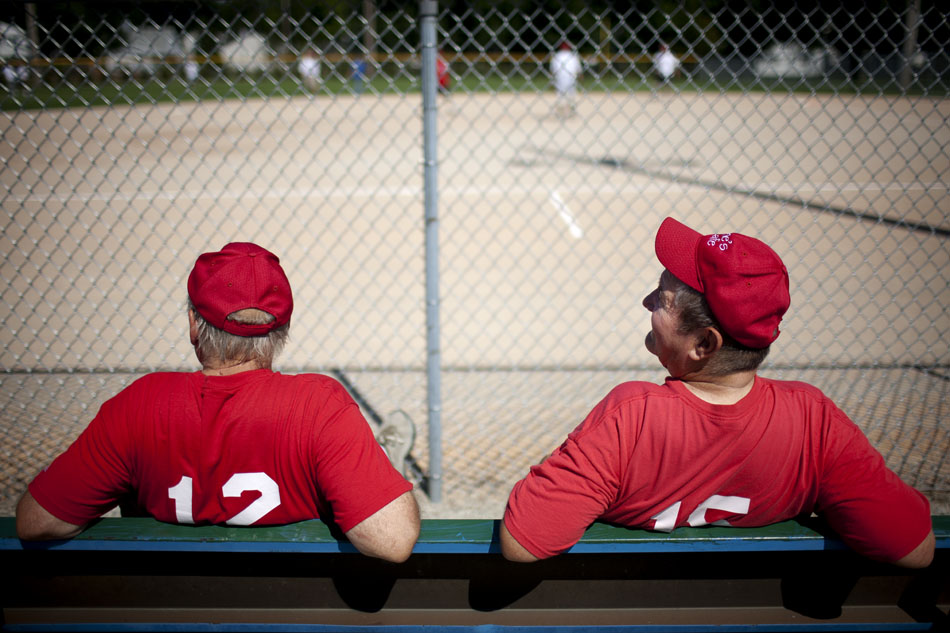 Carl Montgomery, right, and Mike Smith, both players on the Irene's Cafe team, watch the action from the bench during a Mishawaka senior softball league game on Tuesday, July 31, 2012, at Normain Park in Mishawaka. (James Brosher/South Bend Tribune)