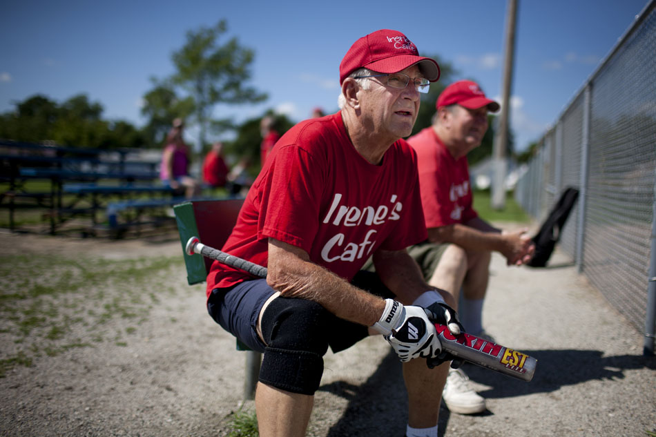Bob Matuszak, a player on the Irene's Cafe team, waits on the bench for his turn to bat during a Mishawaka senior softball league game on Tuesday, July 31, 2012, at Normain Park in Mishawaka. The league is for players 62 and older. It features a wide first base, and two home plates to help the older players avoid collisions. (James Brosher/South Bend Tribune)