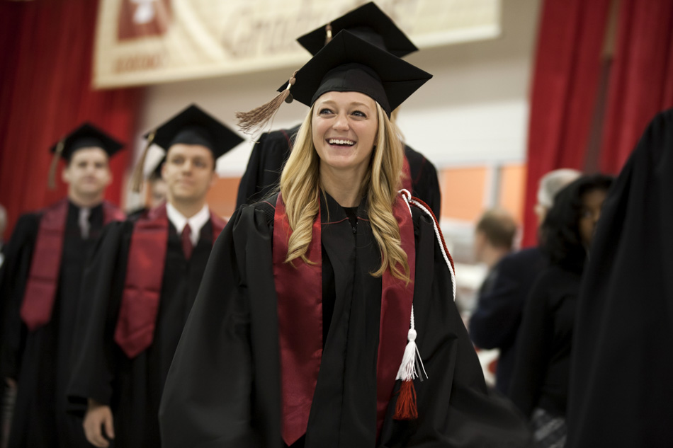 A graduate smiles as she walks in the processional during IU Kokomo Commencement on Tuesday, May 12, 2015, at Ivy Tech in Kokomo. (James Brosher/IU Communications)