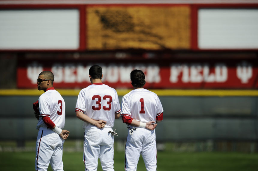 Indiana's Micah Johnson, left, Michael Basil and Tyler Rogers face the outfield during the playing of the National Anthem before a game against St. Francis on Friday, March 26, 2010, at Sembower Field.