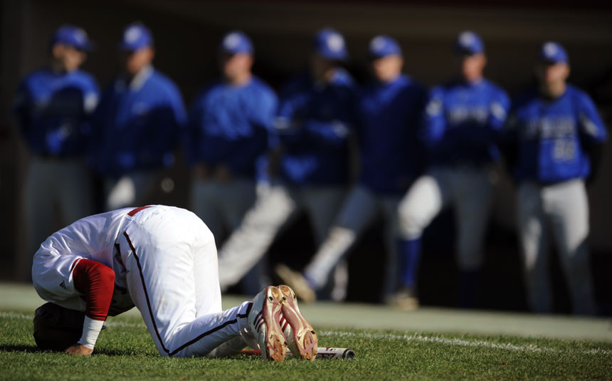 Indiana's Micah Johnson winces in pain on the ground after a foul ball hit his ankle during an at-bat in a game against St. Francis on Friday, March 26, 2010, at Sembower Field. IU won 7-3.