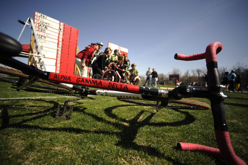 A Schwinn bicycle belonging to Alpha Gamma Delta sits in the infield as the team, background, poses for photos after qualifiying for the Little 500 on Saturday, March 27, 2010, at Bill Armstrong Stadium.