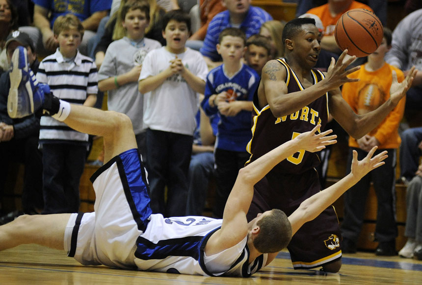North's Damon Brown tries to get a hold of a loose ball along with Columbus North's Evan Dodd during a 4A sectional semi-final on Friday, March 5, 2010, at Columbus North High School.