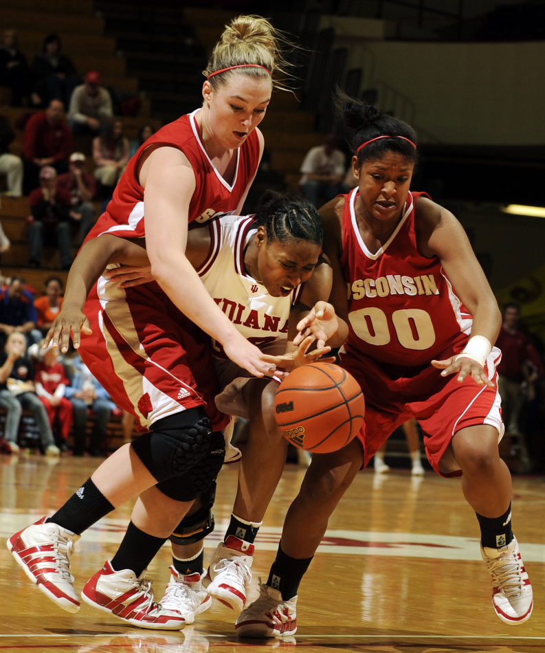 Indiana guard Jori Davis, middle, reacts after Wisconsin center Tara Steinbauer, left, and guard Jade Davis (00) strip the ball away during a game on Thursday, Jan. 28, 2010, at Assembly Hall in Bloomington, Ind. IU's Davis had 21 points as Wisconsin won 55-47.