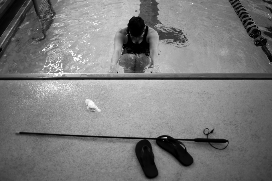 Sharlee Davis stretches her legs between laps during a swim on Saturday, Feb. 27, 2010, at the Monroe County YMCA in Bloomington, Ind. Davis suffers from retinitis pigmentosa, a eye disease that progressively gets worse over a period of several years. Diagnosed with the disease more than 20 years ago when she was 21, and she now can only make out light and dark patches.