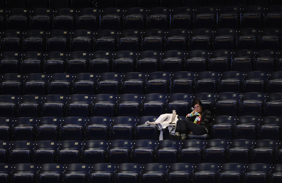 A lone fan watches the action from an empty section during a NCAA women's basketball game between Indiana and Illinois on Thursday, Jan. 7, 2010, at Assembly Hall in Bloomington, Ind. Bad weather and Christmas break contributed to an extremely sparse crowd at the game although the official attendance was listed at 1,350.