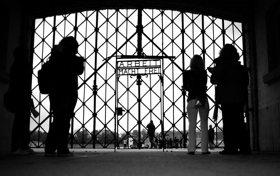 Visitors photograph the gate at the main entrance of the Dachau Concentration Camp on Saturday,  May 22, 2010, in Dachau, Germany. The gate's writing, "Work will set you free," is found at the entrances of most concentration camps.